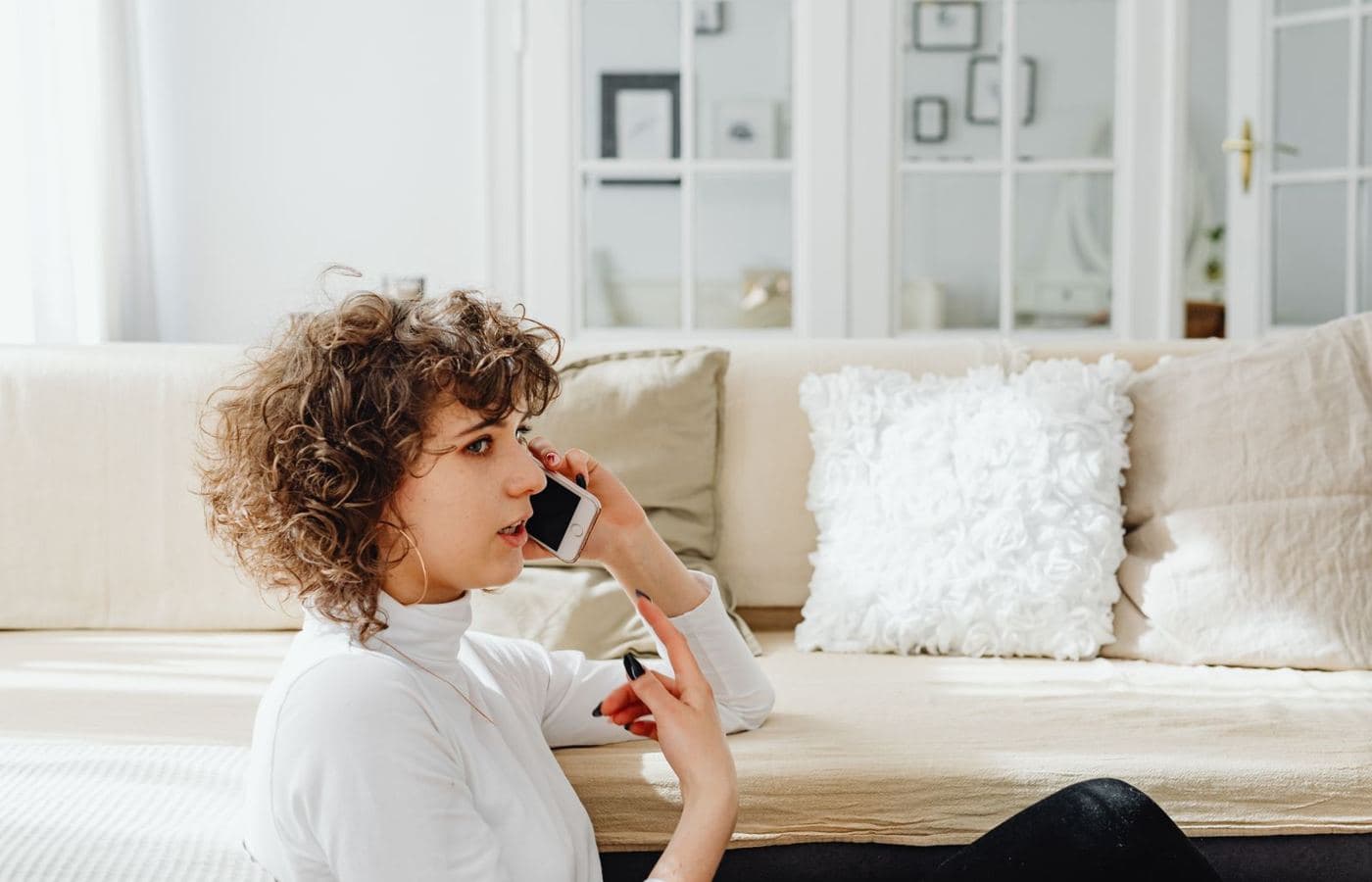 A woman on a phone call at home on her sofa