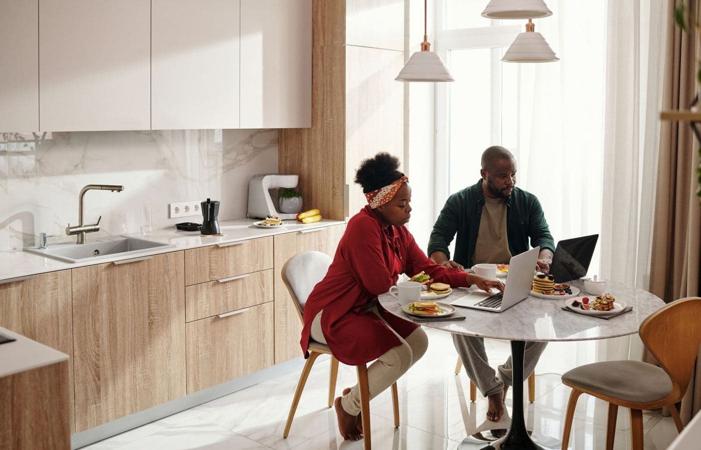 A couple sitting together at their kitchen table