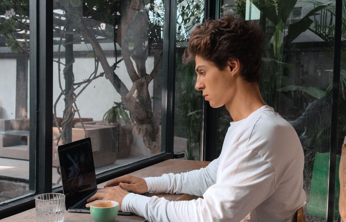 A young man researching options on his laptop